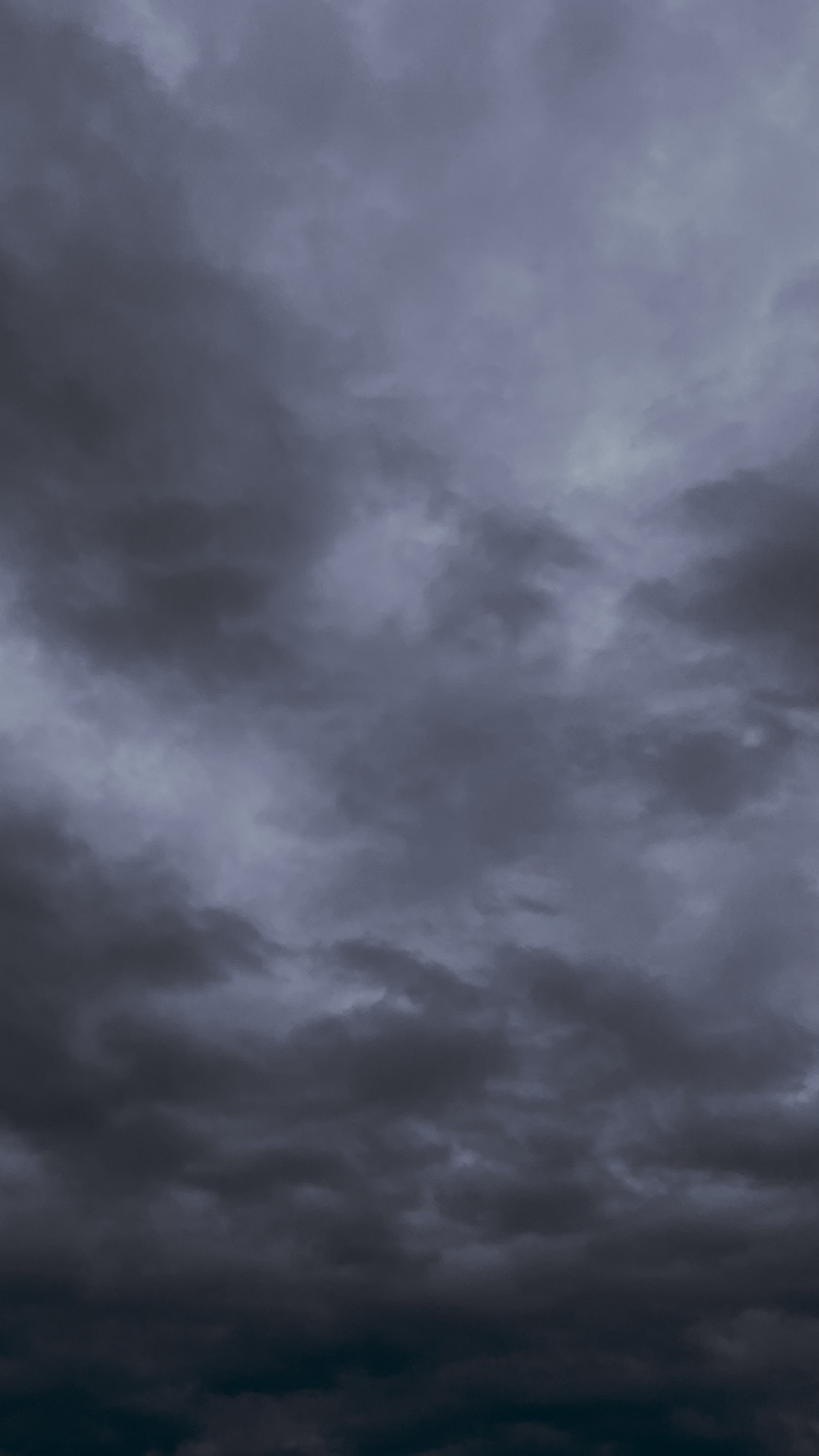 Heavy storm clouds gathering over open land